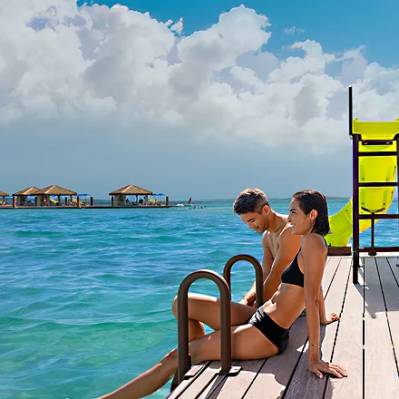 Couple sitting at CocoCay deck HP Mobile 750 910 FAM NF 2x